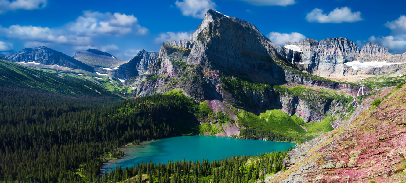 A landscape of mountains and a turquoise lake below