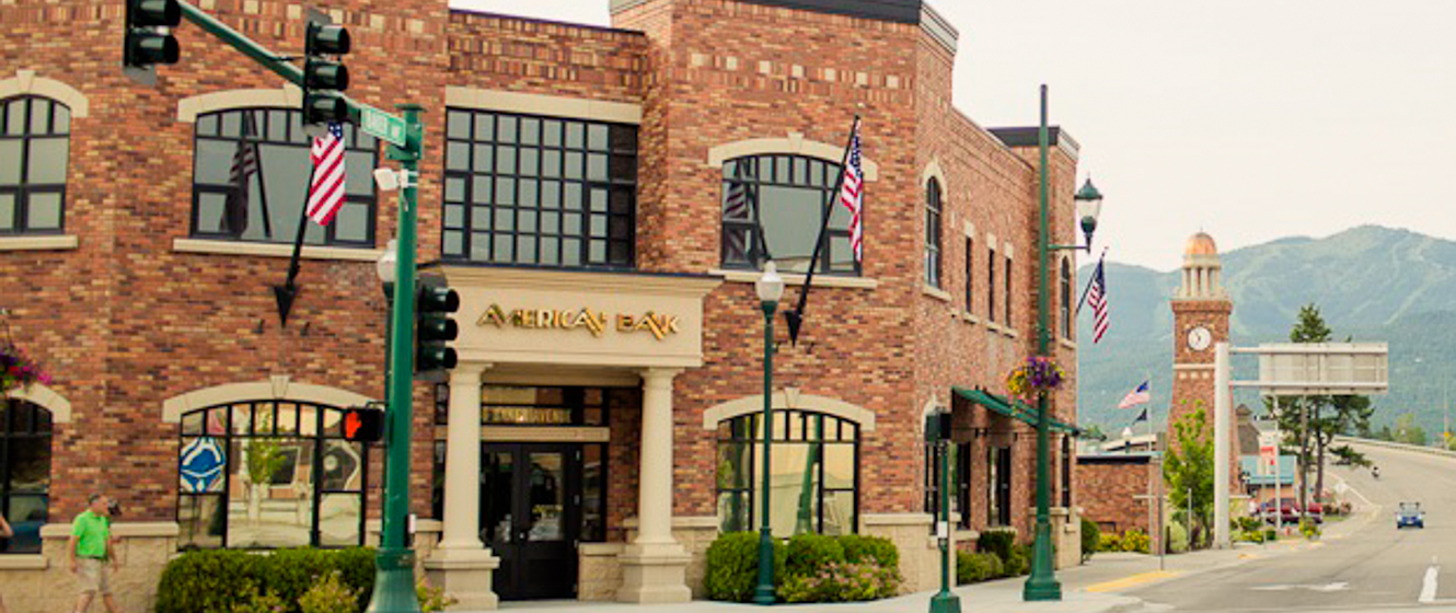 Street view of American Bank in Whitefish, Montana, with red brick exterior walls