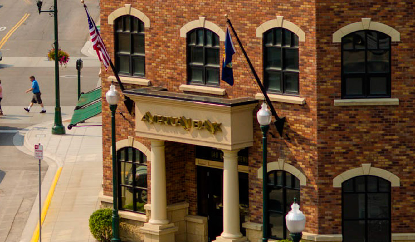 Street view of a red brick American Bank branch.
