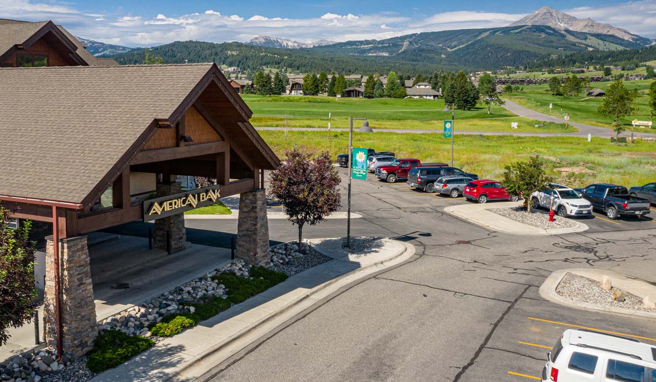 American Bank Big Sky Branch building with mountains in the background.