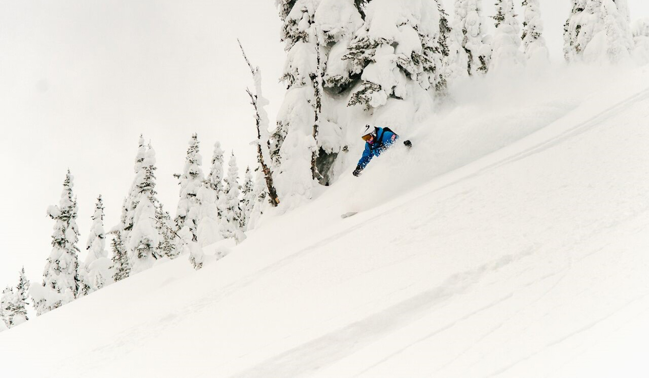 Downhill skier in soft powder snow