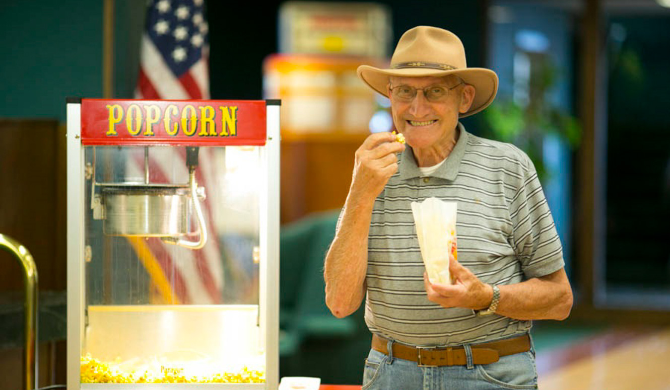 Gentleman eating popcorn.